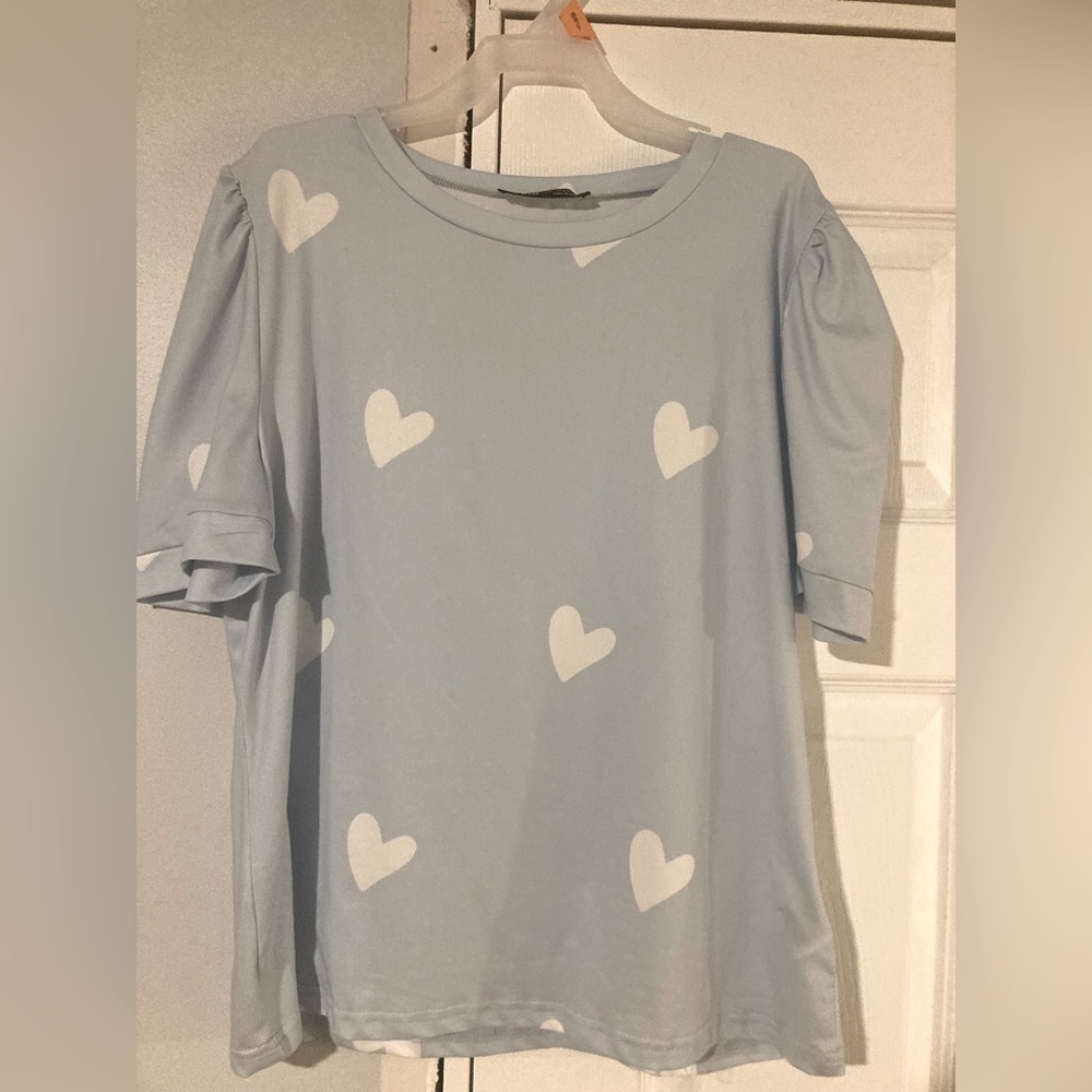 Women’s blue top with white hearts